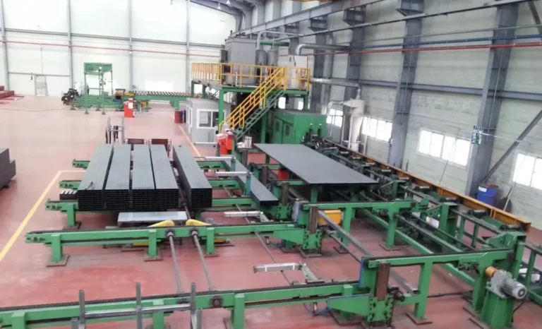 Square tube on the transfer racks of the coating line, seen down the bay