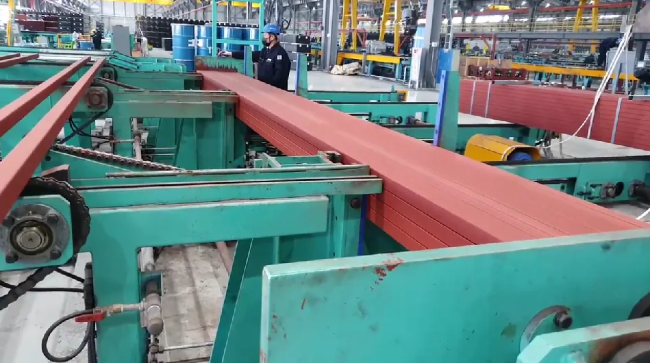 Painted square tube moving along the roller conveyor