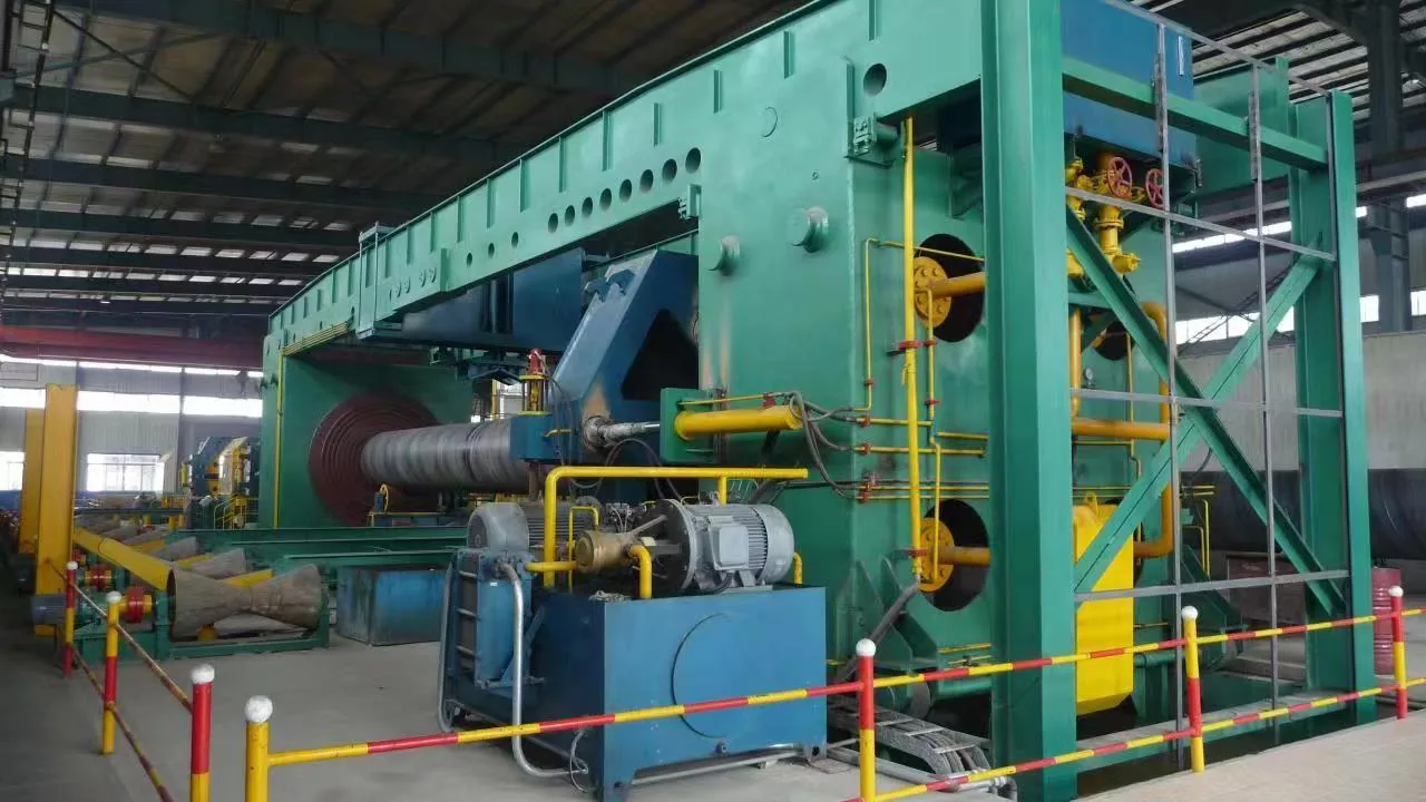 Forming section of a spiral welded pipe mill with the steel coil behind