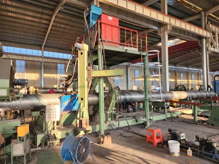 Inner welding station with spiral pipe leaving the forming section