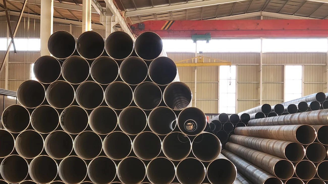 Stacks of finished large-diameter spiral welded pipe from a spiral tube making machine