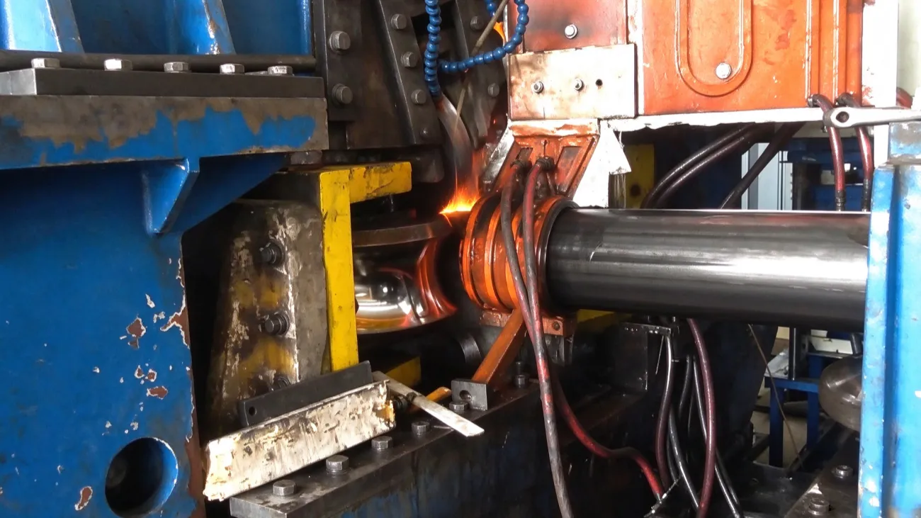 Induction coil with the pipe passing through on the API line
