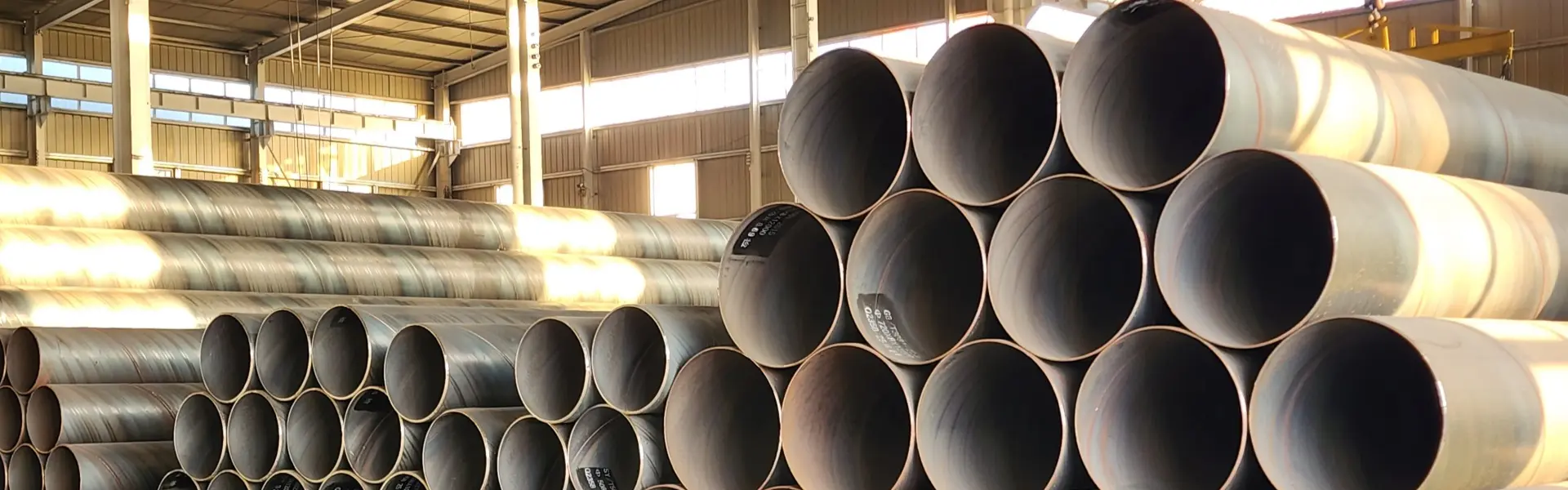 Large-diameter steel pipes stacked in the warehouse