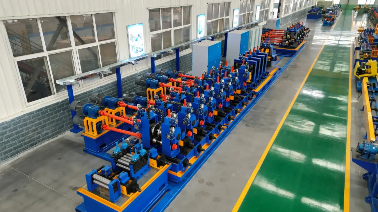 Blue tube mill line running the length of a white-walled workshop