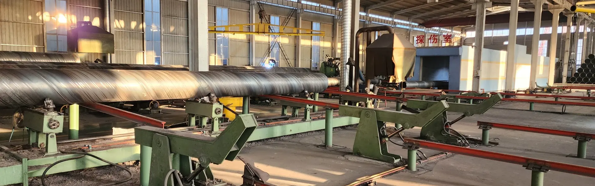 Spiral welded pipe leaving the SSAW mill on the run-out table